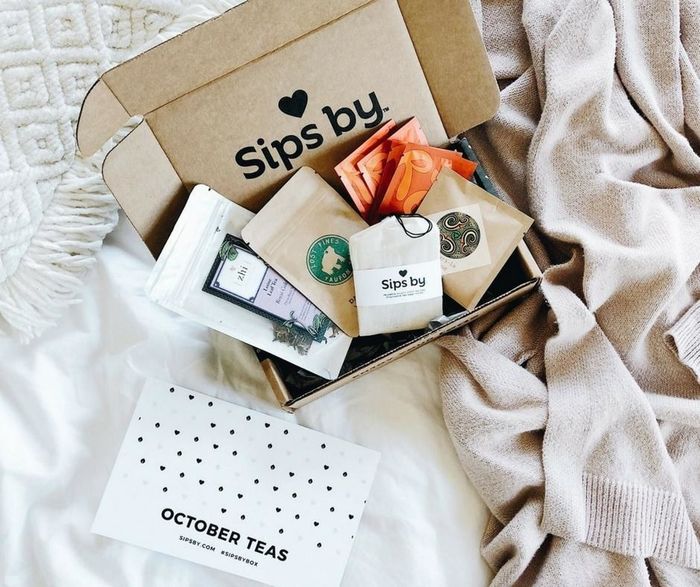 A beautifully curated box packed with an assortment of tea-related delights.