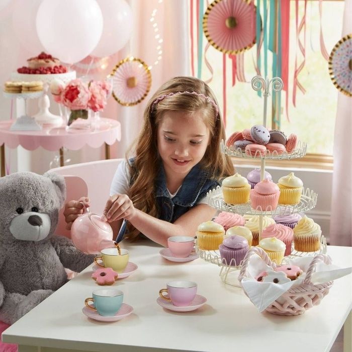 A child enjoying a playful moment with the tea party set