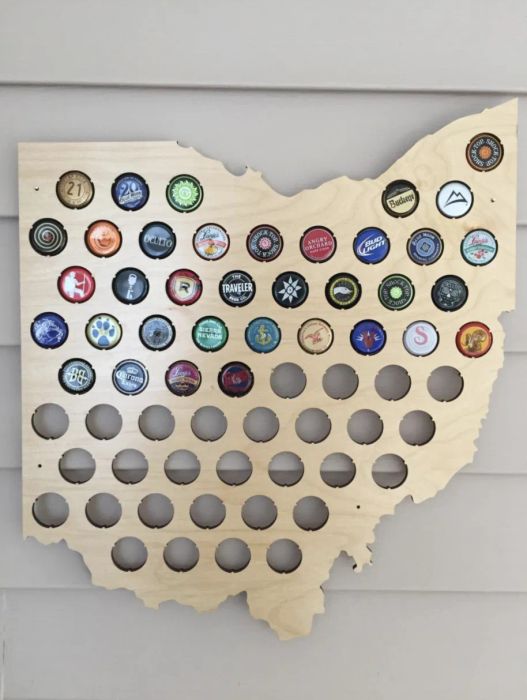An image of the map filled halfway with beer bottle caps, marking the brews they've enjoyed so far.