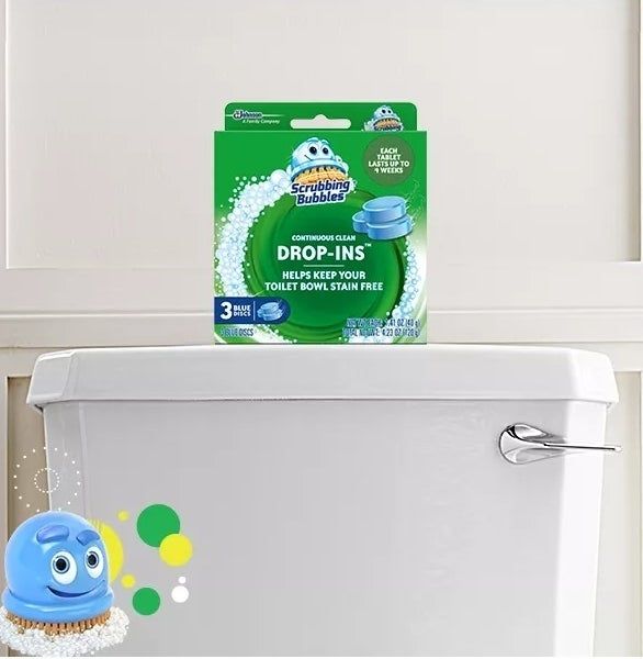 Scrubbing Bubbles Drop-Ins product displayed on a toilet tank lid, showcased in its packaging for cleaning toilet bowls and preventing stains.