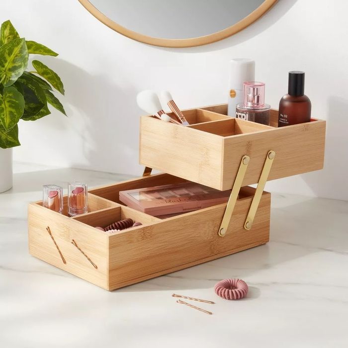 The hinged organizer, filled with various items, has been extended to its full capacity.