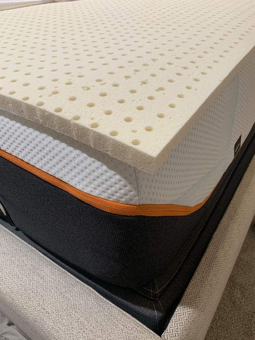reviewer image of latex mattress topper placed on a bed