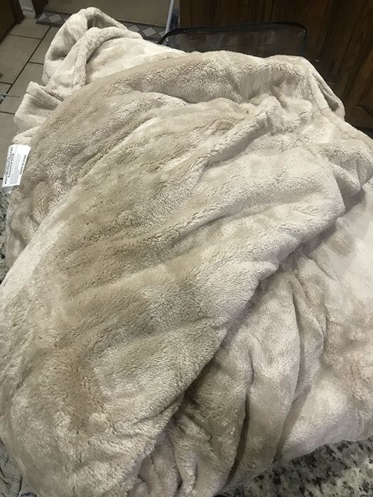 A reviewer posted an image of the fleece blanket, emphasizing its warmth and comfort.