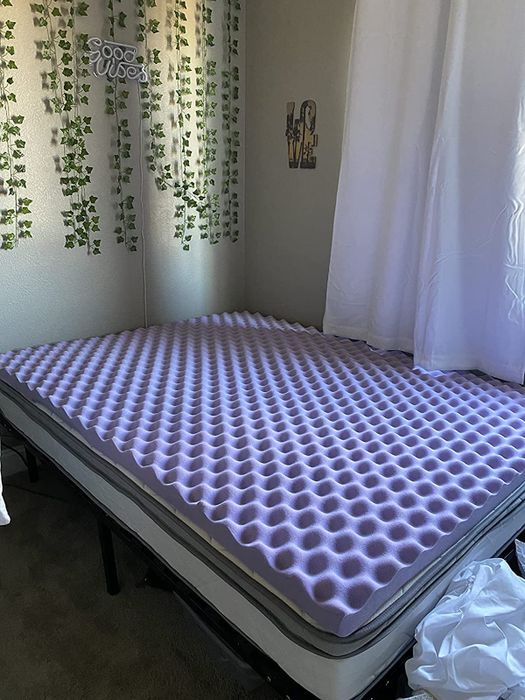 A photo of a lavender-infused egg crate mattress topper on a mattress, taken by a reviewer.