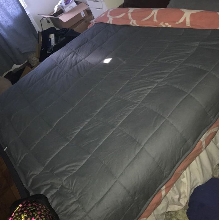 A reviewer shared an image of a blanket spread across a bed, showcasing its cozy appeal.