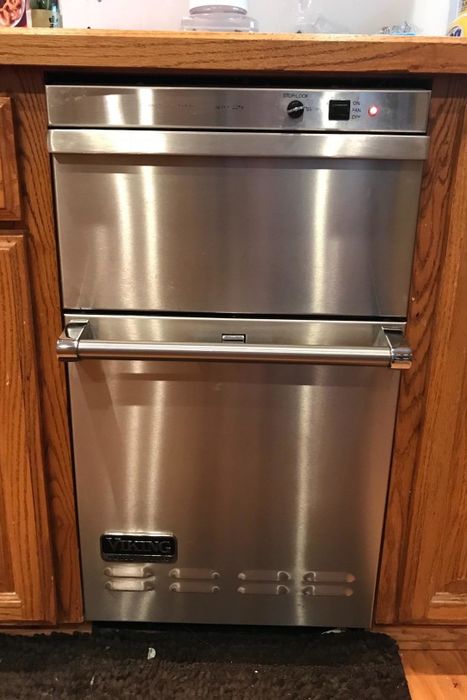 A reviewer’s photo showing the same dishwasher now shiny and spotless.