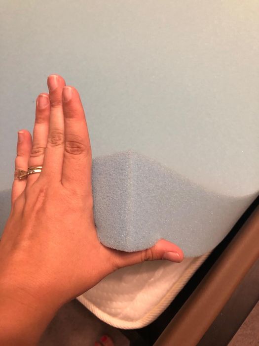 A photo of a hand on a cooling blue mattress topper, taken by a reviewer.