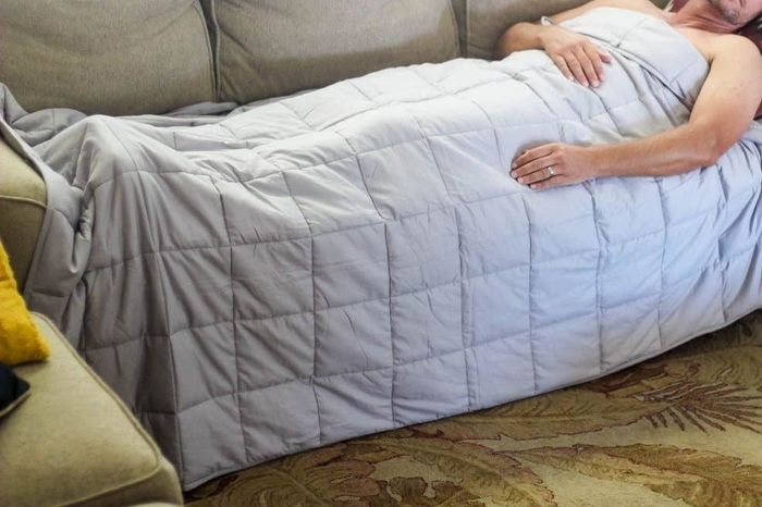 Image from a reviewer showing themselves relaxing under the blanket