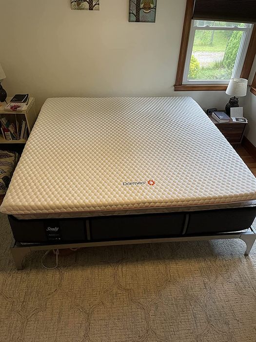 Image from a reviewer showing the mattress topper on a bed