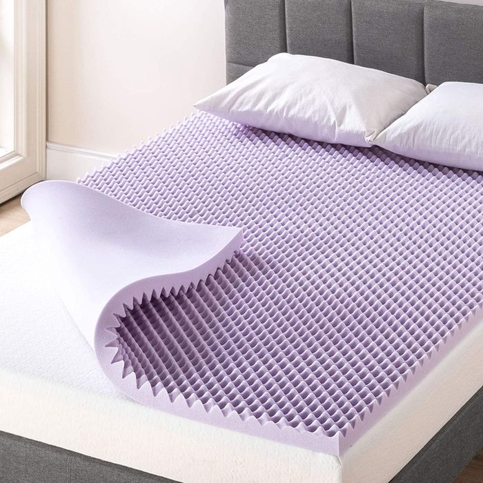 A lavender-infused egg crate mattress topper placed on top of a mattress.