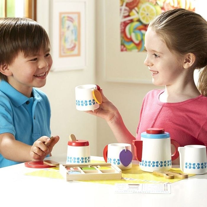 Children playing with a tea set