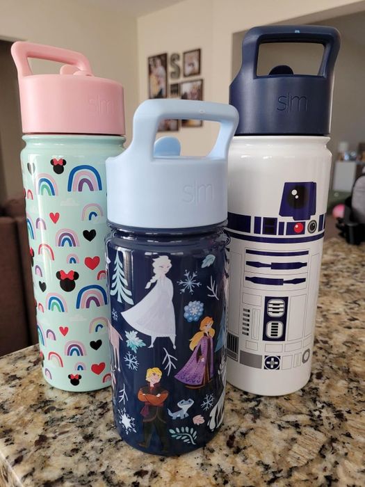 three water bottles featuring Disney themes