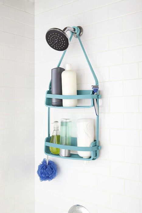 A caddy filled with various tubes, hanging securely from the showerhead