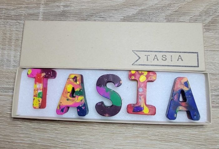 a set of crayons spelling out the name Tasia