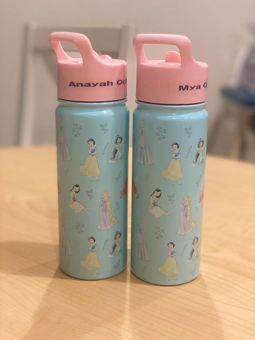 two water bottles adorned with Disney princess designs