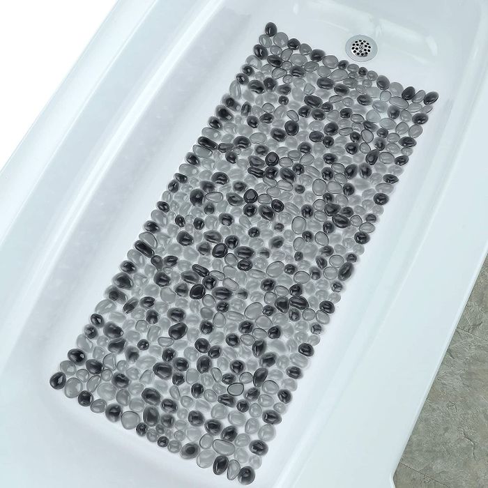 A black shower mat placed neatly inside a shower