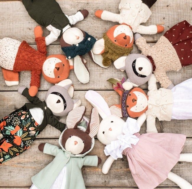 a circle of stuffed animals dressed in various outfits