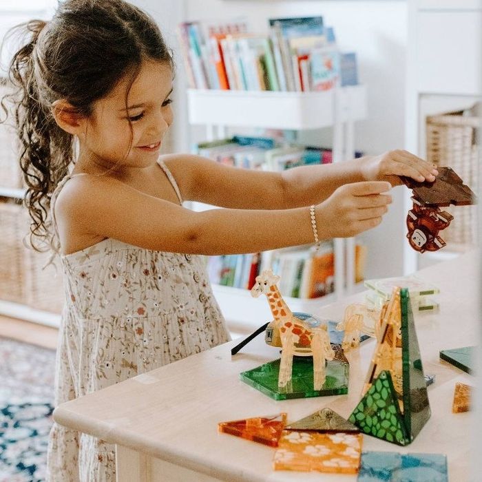 A child playing with Magna-tiles.