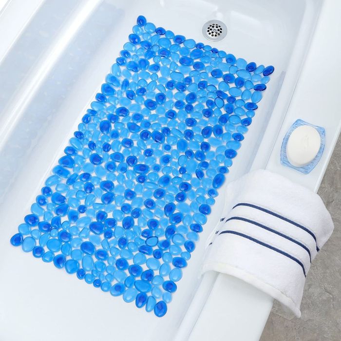 A blue shower mat positioned in a shower setting