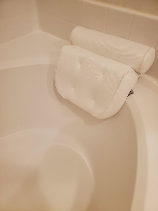 The bathtub pillow placed inside a tub