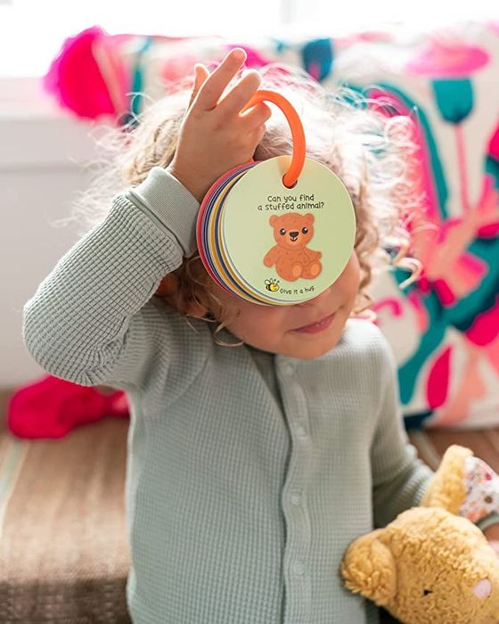 A child holding the ring of scavenger hunt cards