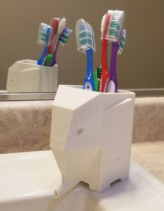 An elephant-inspired toothbrush holder designed to store toothbrushes inside