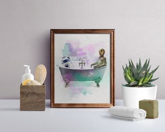 Star Wars-inspired art print featuring R2-D2 and C-3PO in a colorful bathtub displayed atop a bathroom vanity
