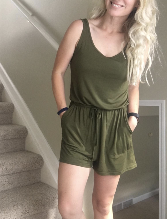 reviewer wearing an olive green romper featuring a tie waist and pockets