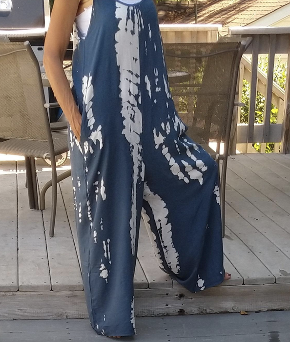 reviewer modeling the white and blue tie-dye jumpsuit