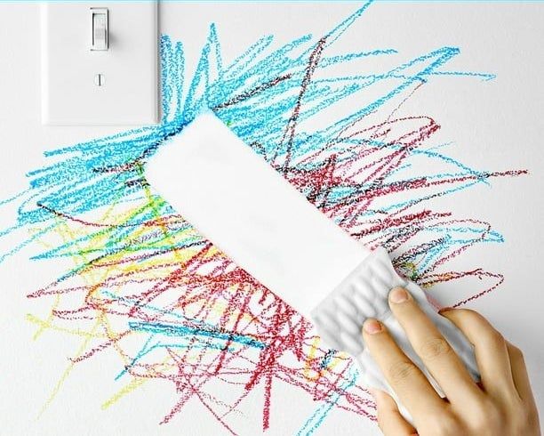 The eraser in action, removing marks from a wall effortlessly.