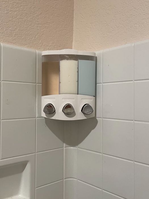 A shower dispenser mounted in a reviewer's shower