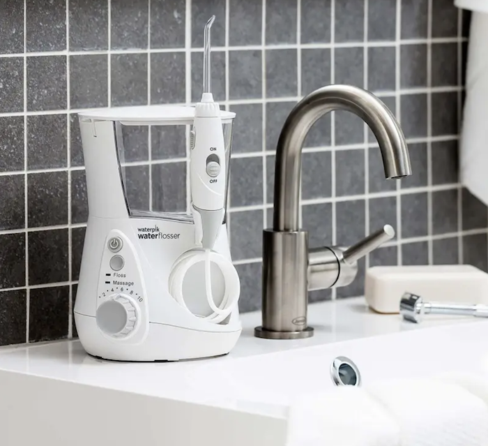 A Waterpik water flosser placed neatly on a bathroom countertop