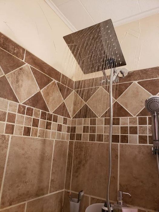A reviewer's shower featuring a newly installed rainfall showerhead