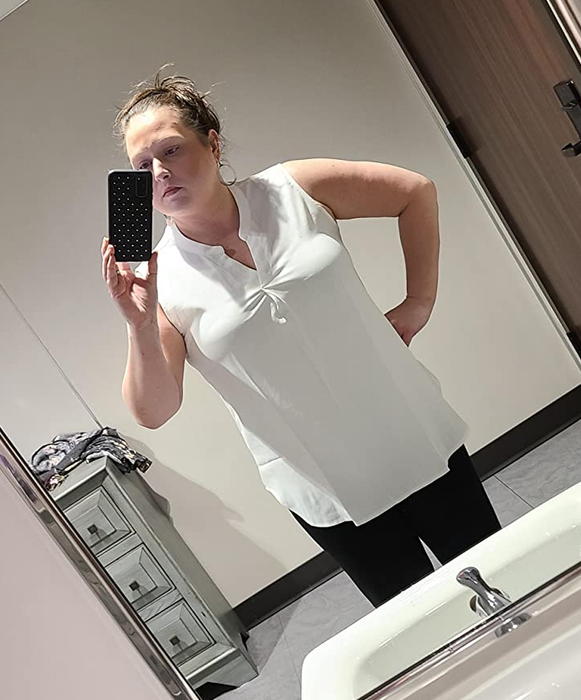 Photo of reviewer wearing a white blouse.
