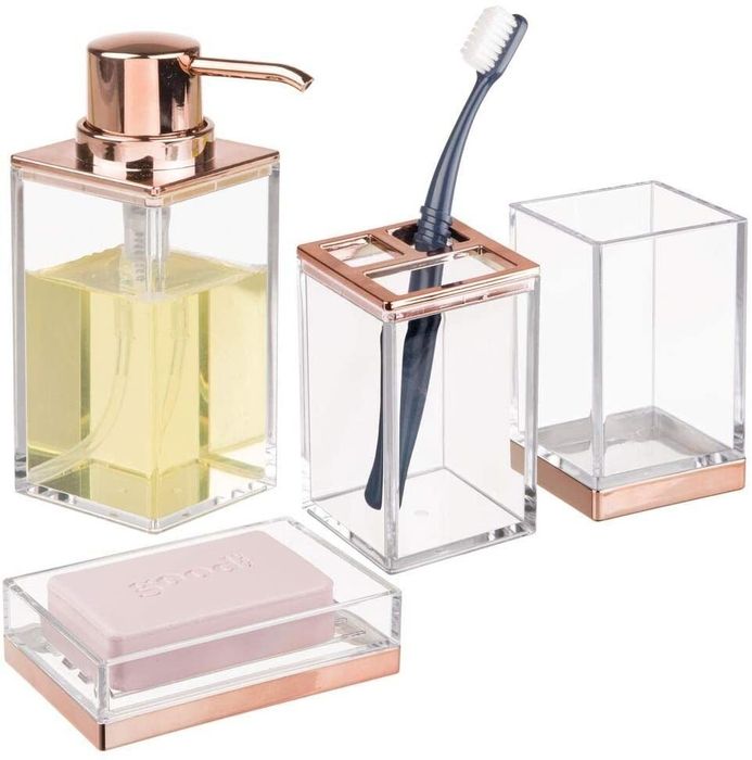 A set of four elegant bathroom organizers featuring rose gold accents