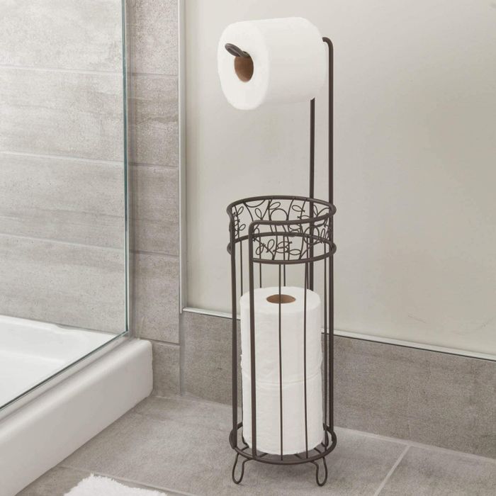 A toilet paper holder elegantly placed in a bathroom setting