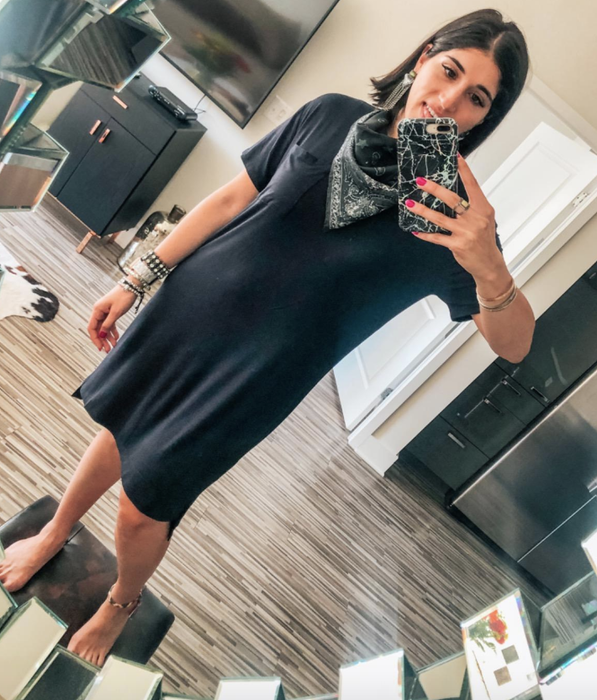 reviewer modeling the black dress