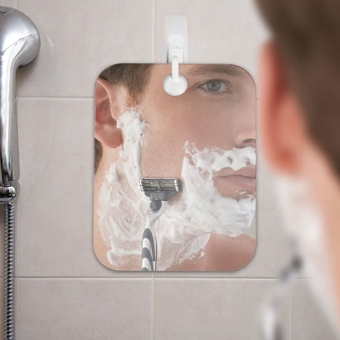 A model shaving while using a fog-free mirror