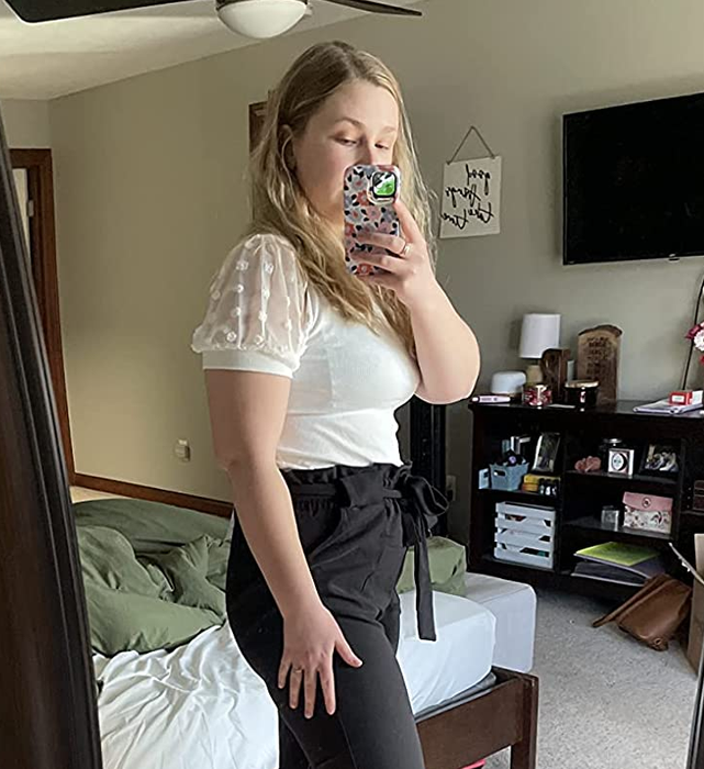 Image of reviewer wearing a white shirt paired with black pants