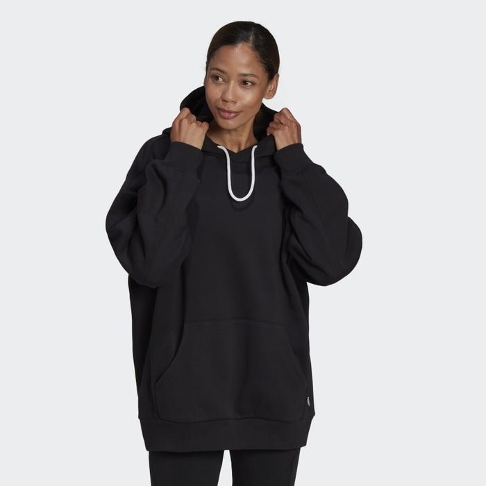 The model is seen wearing the black hoodie, complete with a white infinity drawstring.