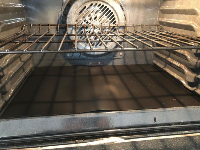 Reviewer photo showing an oven liner neatly placed at the bottom of the oven.