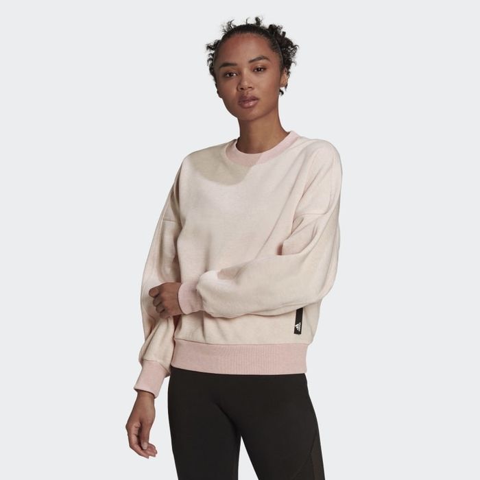 The model is seen wearing the pink crewneck sweatshirt.