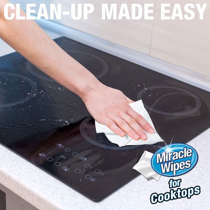 Model demonstrating the use of Miracle Wipes on a stove top
