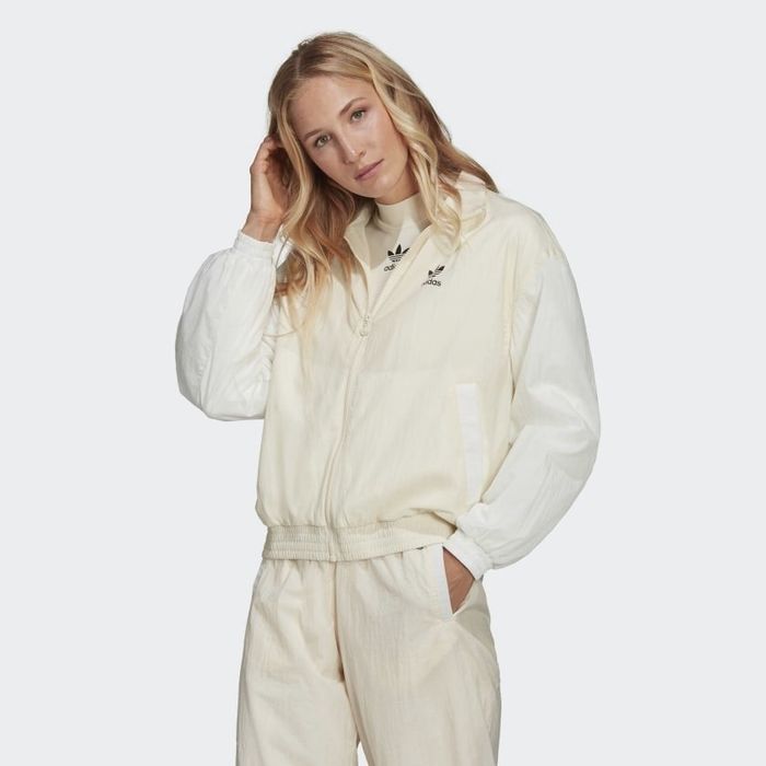 The front view of a model showcasing the jacket in cream.