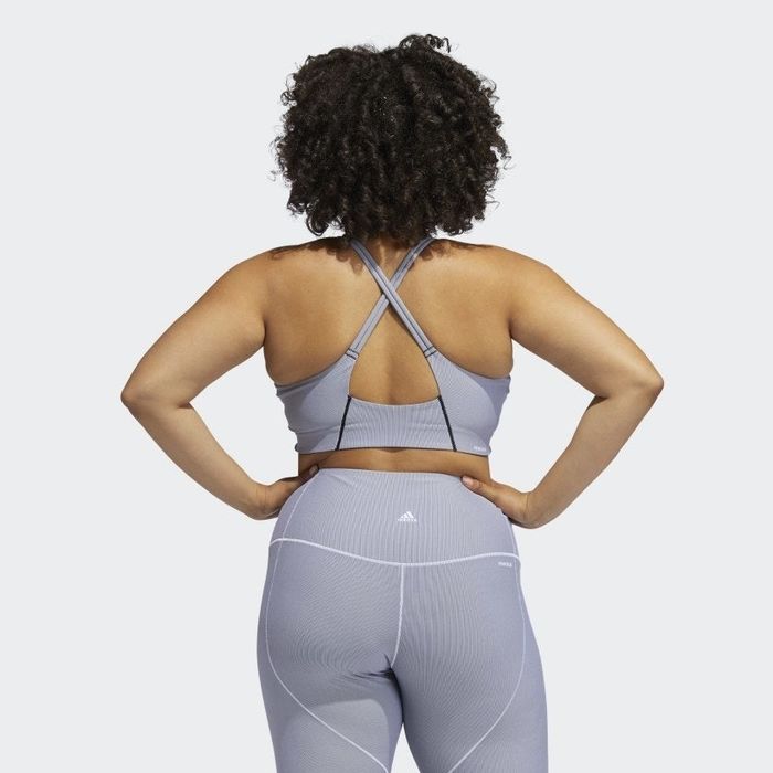 Back view of the model wearing the criss-cross sports bra in lavender.