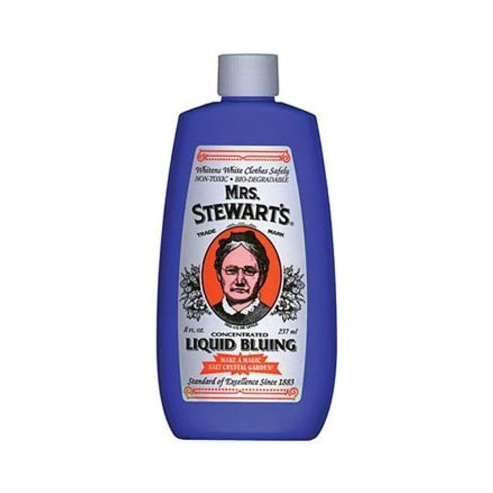 Mrs. Stewart's Concentrated Liquid Bluing bottle, showcasing a vintage-style portrait and details about its effectiveness in cleaning and whitening fabrics