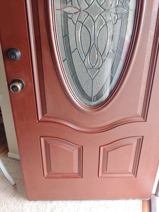 The same door after being treated, now displaying a deep, rich mahogany hue