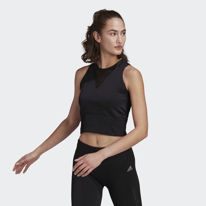 The model is seen sporting the cropped tank in black.