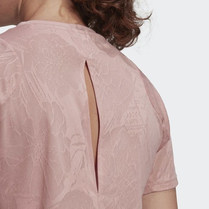 Close-up shot of the floral pattern and the slit at the back of the shirt.