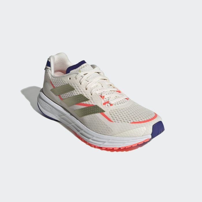 front view of the sneakers in a mix of beige, coral, navy, white, and gold